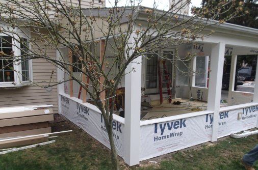 home addition in progress showing framing and Tyvek insulation